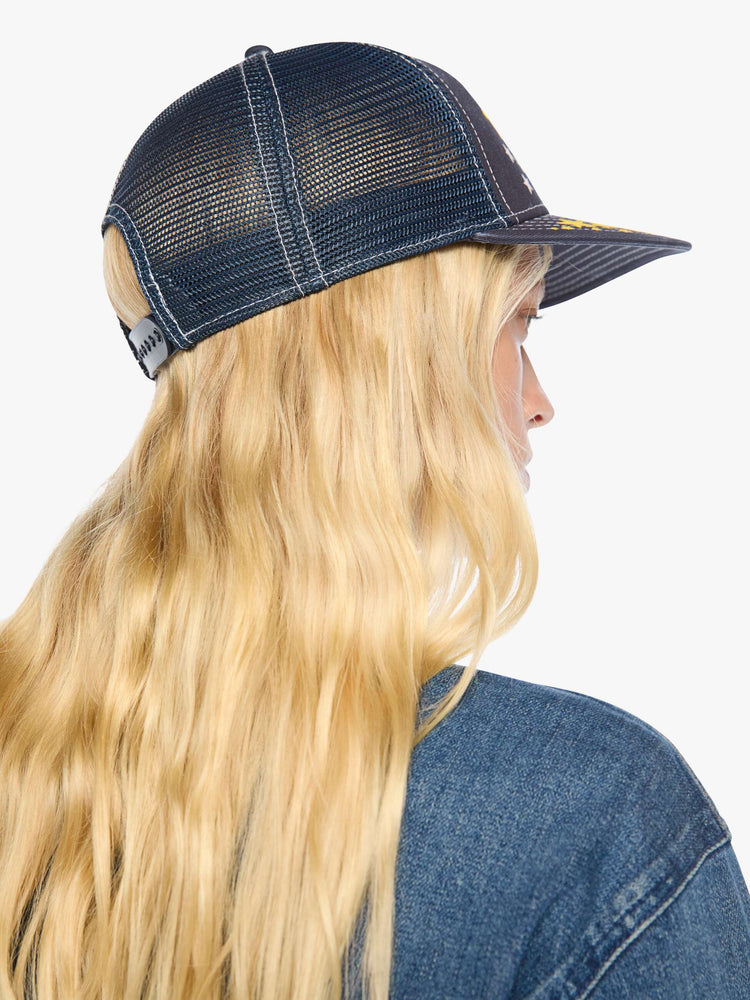 Back on model view in a vintage-inspired trucker hat designed in navy with a Pegasus graphic and MOTHER's name in yellow on the front.