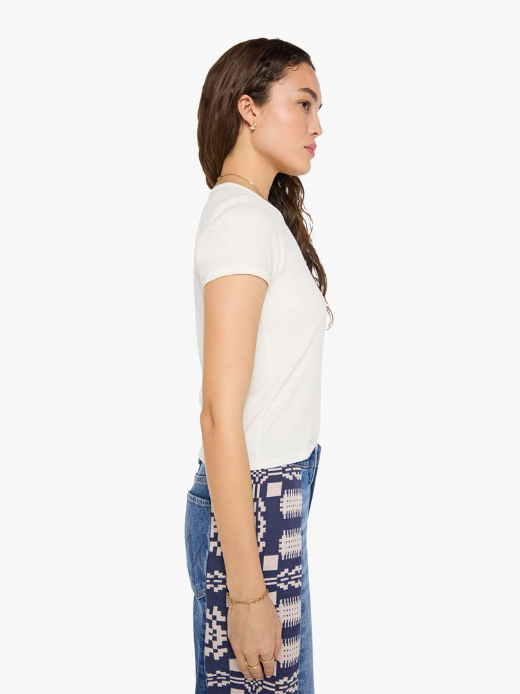 Side view of woman in an off-white tee features a faded, air-brushed tiger graphic and MOTHER's name in black on the front.