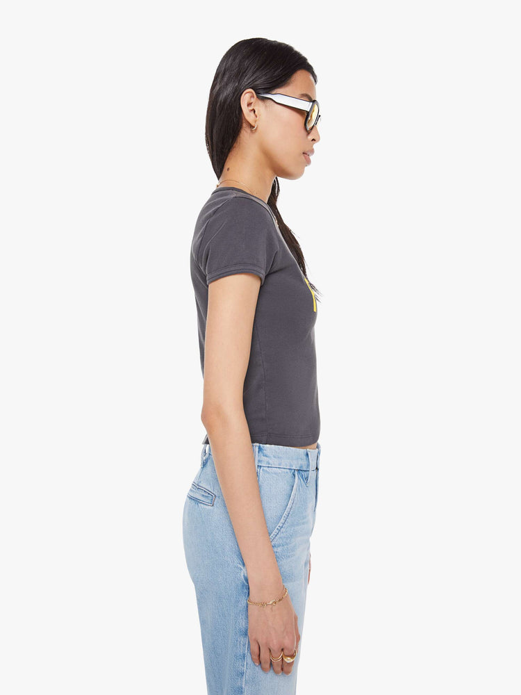 Side view of a  faded black tee with a Mini Skirts Forever features yellow text on the front.