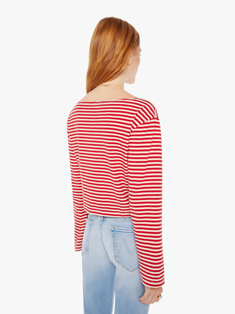 Back view of a woman red and white stripe pattern boatneck top with long sleeves, drop shoulders, a cropped hem and boxy fit.