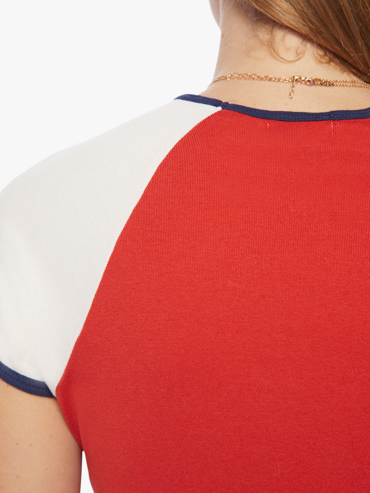 Swatch view of a woman crewneck designed with white sleeves, navy trim and a vintage-inspired text graphic on the front in white and blue.