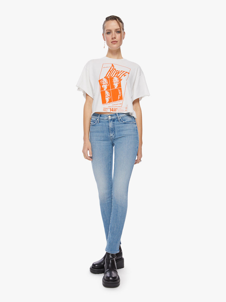 Full body view of a woman oversized cropped tee pays tribute to the superstar’s 1983 Serious Moonlight Tour, with drop shoulders, subtle bat wings, a raw hem and a boxy fit.