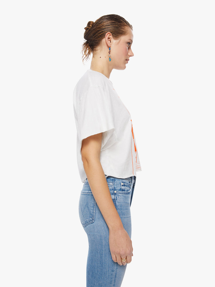 Side view of a woman oversized cropped tee pays tribute to the superstar’s 1983 Serious Moonlight Tour, with drop shoulders, subtle bat wings, a raw hem and a boxy fit.
