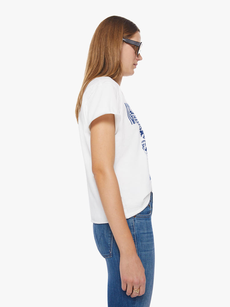Side view of a woman oversized crewneck tee in white that features a bright blue butterfly graphic with text on the front.