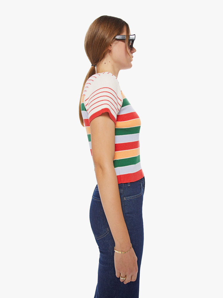 Side view of a woman rainbow stripe scoop neck tee with short sleeves, a slim fit and a cropped hem.