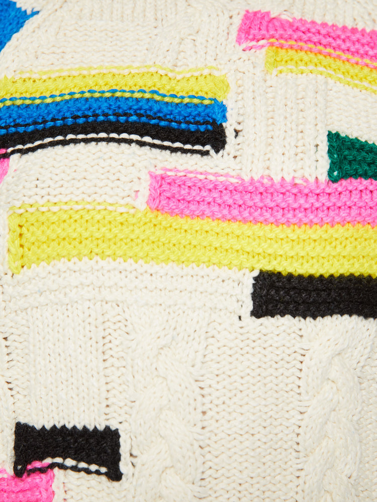 Swatch view of a woman crewneck sweater in an off-white with colorful stripes, checks and cable knits details.