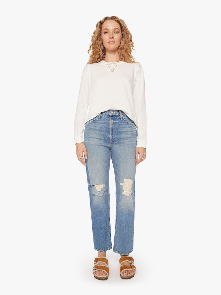 Full body view of a womens white crew neck shirt featuring cuffed long sleeves and a raw cropped hem.