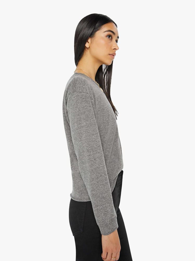 Side view of a womens long sleeve crew neck tee in a heather grey.
