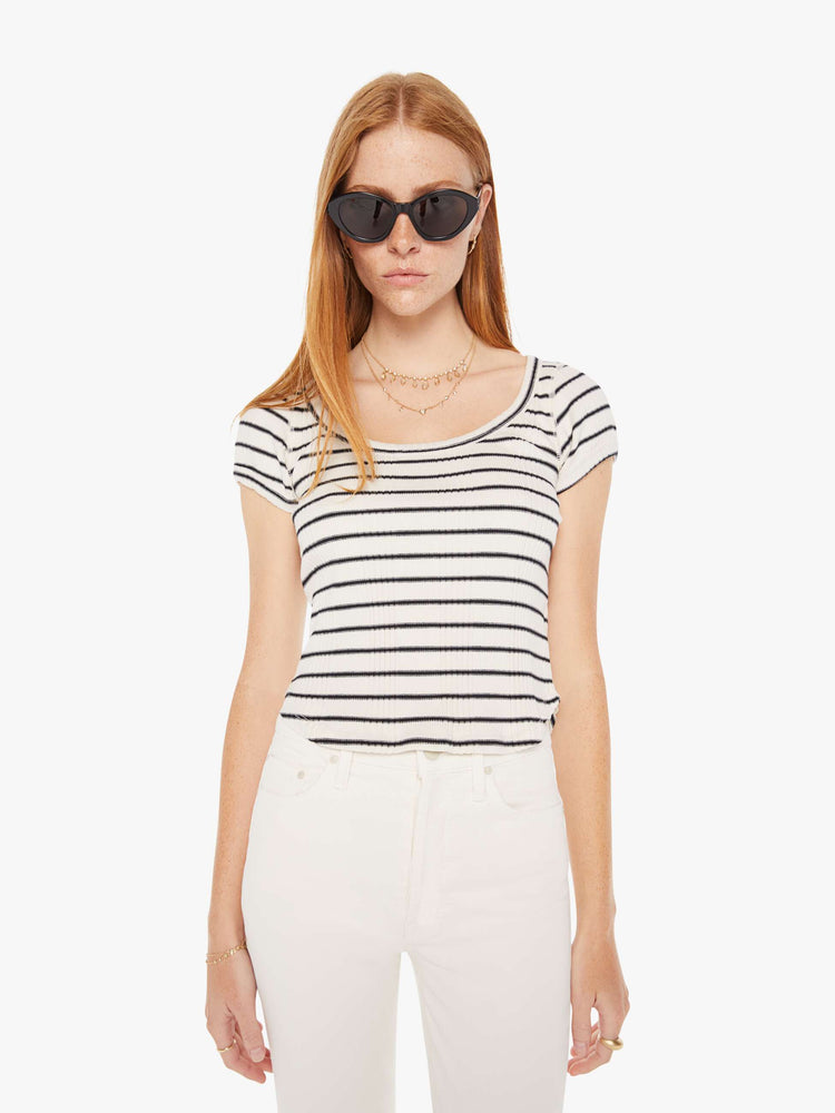 Front view of a womens black and white striped fitted scoop neck tee featuring a curved hem.