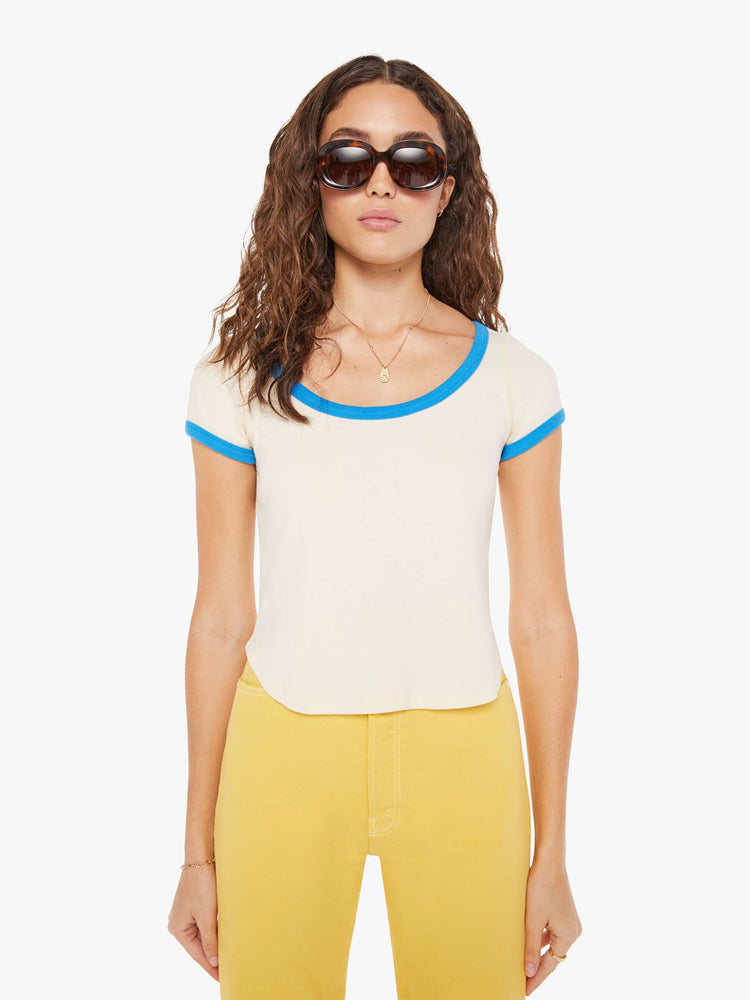Close up view view of a woman in a baby tee designed with a deep scoop neck, short sleeves, a slim fit and a cropped, curved hem.