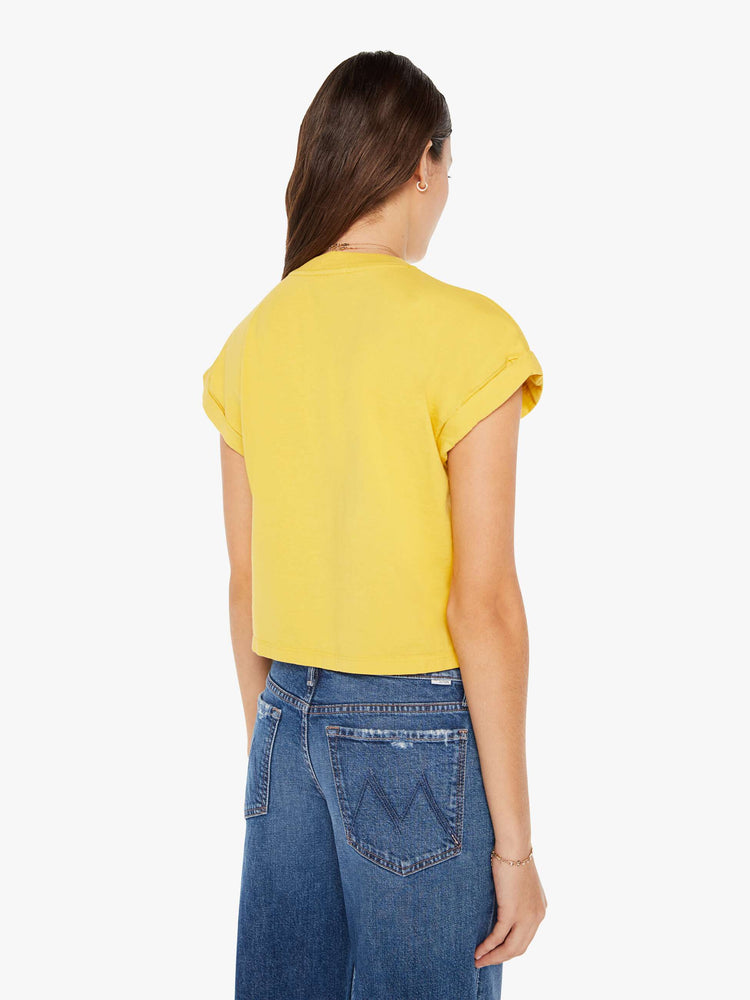 Back view of a womens crew neck tee in yellow featuring a cropped body and front chest pocket.