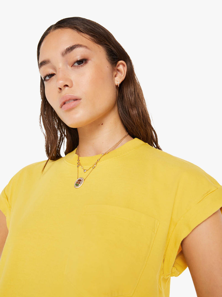 Front close up view of a womens crew neck tee in yellow featuring a cropped body and front chest pocket.