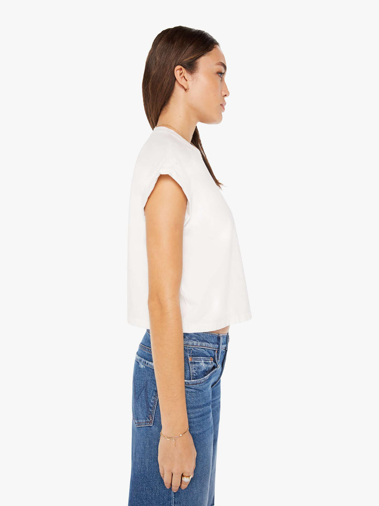 Side view of a womens white crew neck tee featuring a cropped body and chest pocket.