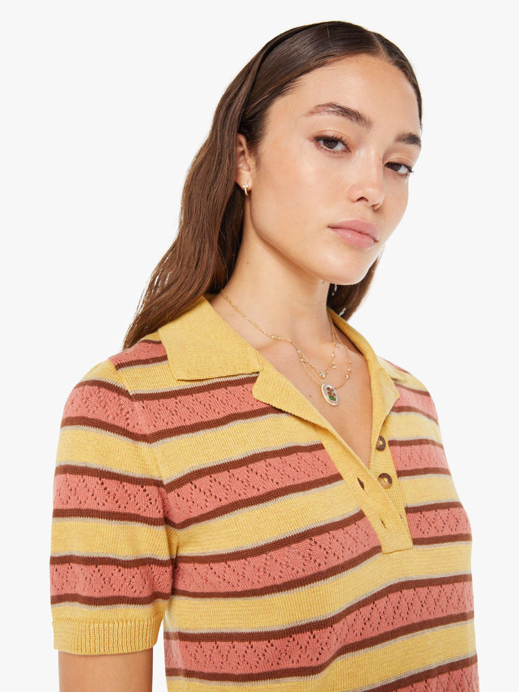 Front close up view of a knit top featuring a multi stripe pattern and button collar.