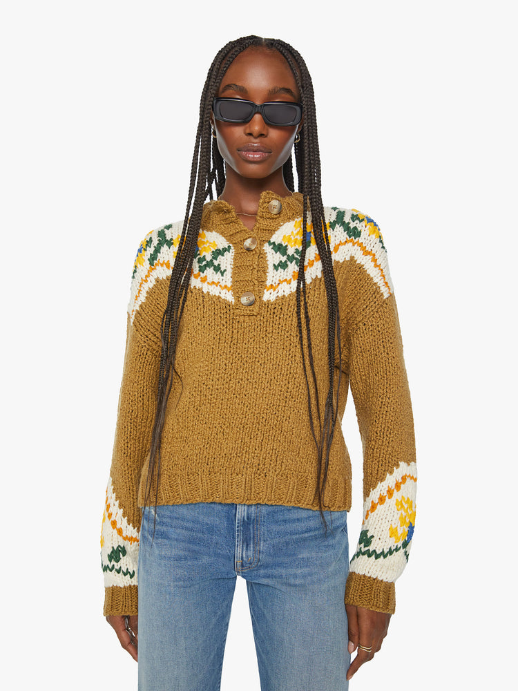 Front view of a woman chunky knit sweater with a buttoned crew neck, drop shoulders and ribbed hems in a mustard yellow with floral details and a red bull on the back.