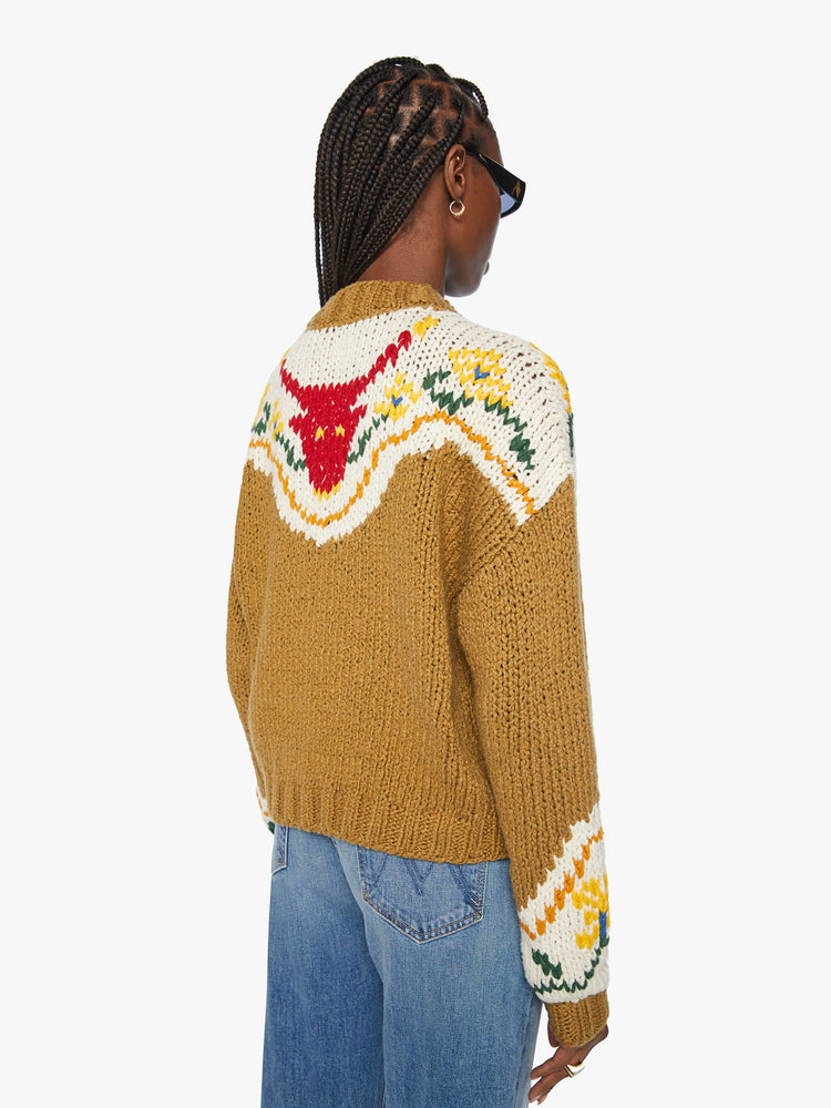 Back view of a woman chunky knit sweater with a buttoned crew neck, drop shoulders and ribbed hems in a mustard yellow with floral details and a red bull on the back.