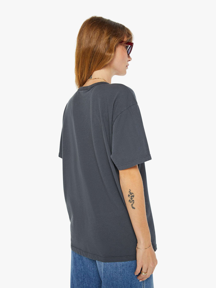 Back view of a woman dark grey tee with a red and blue text graphic on the front.
