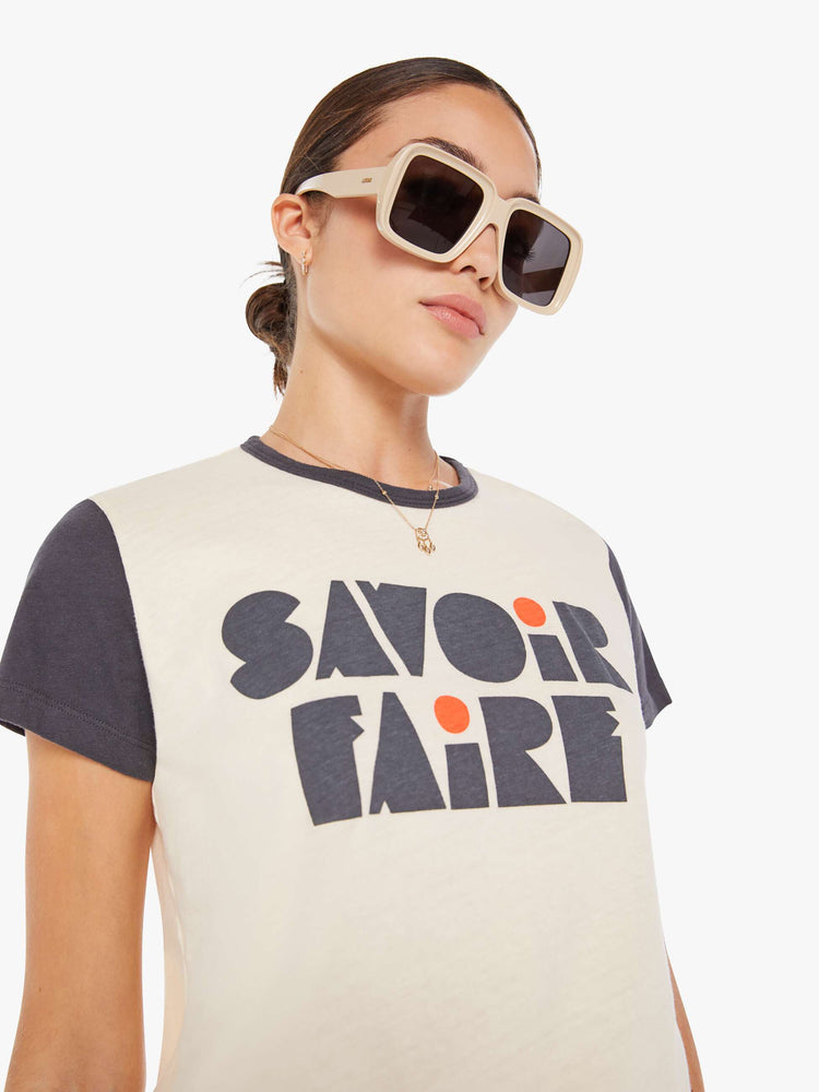 Front close up view of a womens black and white ringer crew neck tee featuring a front graphic that reads "SAVOIR FAIRE".
