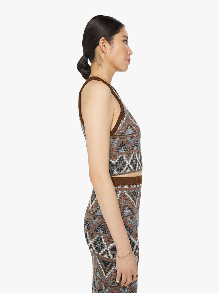 Side view of a woman knit halter top with a ribbed crew neck and a cropped hem in metallic shades of brown, grey and white.