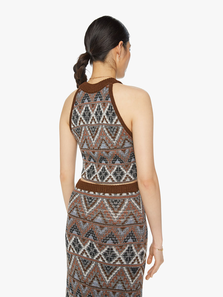 Back view of a woman knit halter top with a ribbed crew neck and a cropped hem in metallic shades of brown, grey and white.