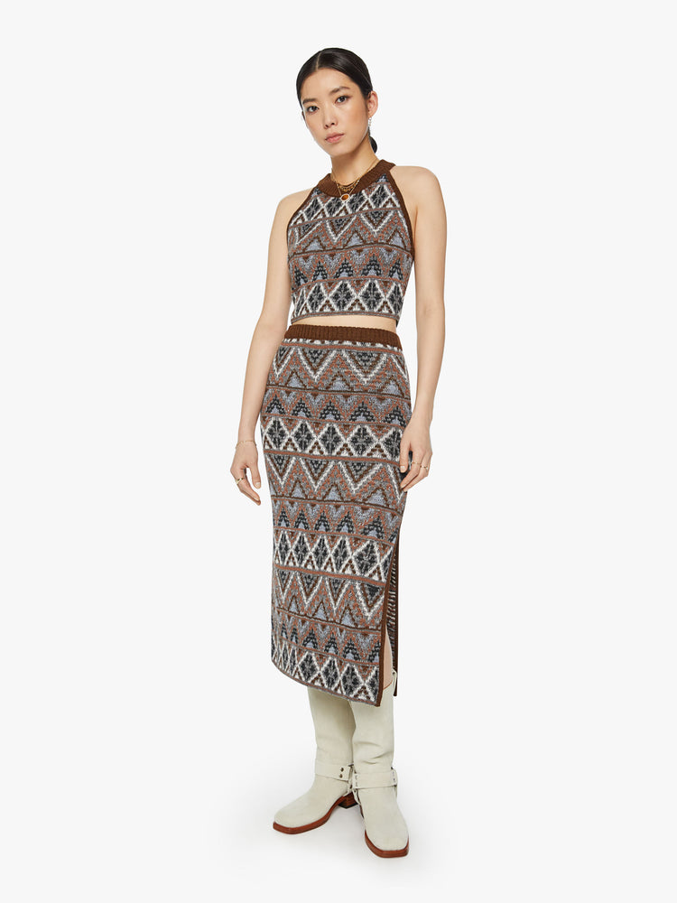 Full body view of a woman knit halter top with a ribbed crew neck and a cropped hem in metallic shades of brown, grey and white.