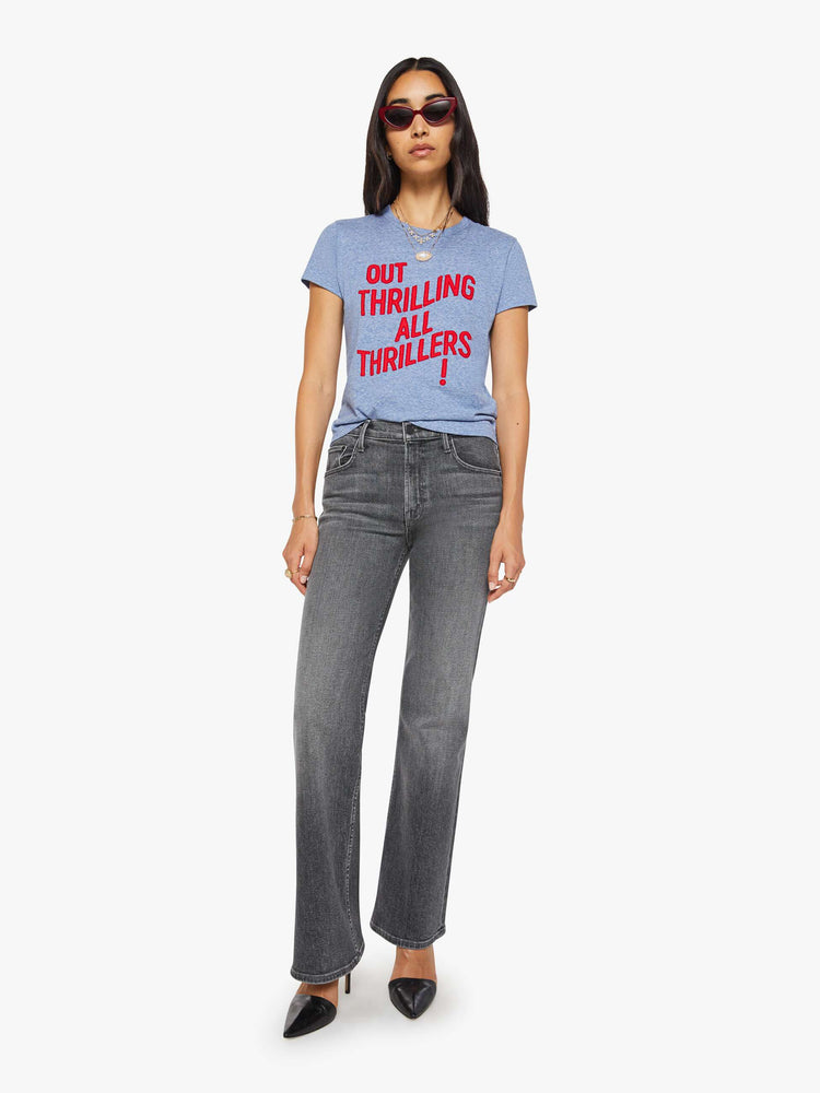 Full body view of a woman in a heathered blue tee features a red block text applique on the front.