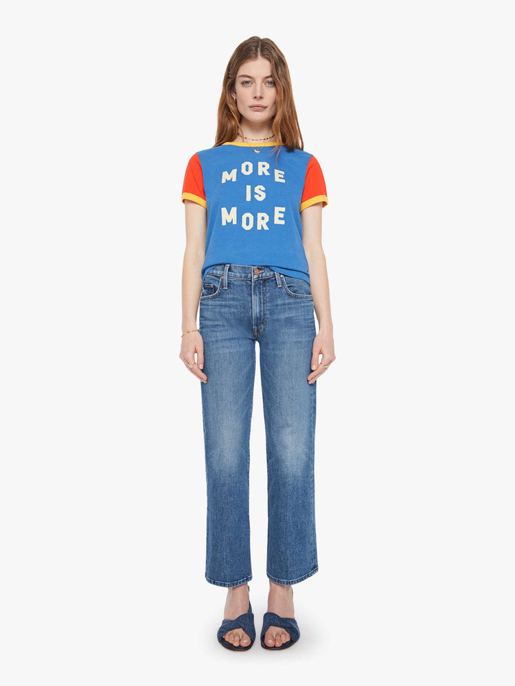 Full body  view of a woman in blue crewneck tee with extra-short sleeves and a cropped hem and yellow trim.