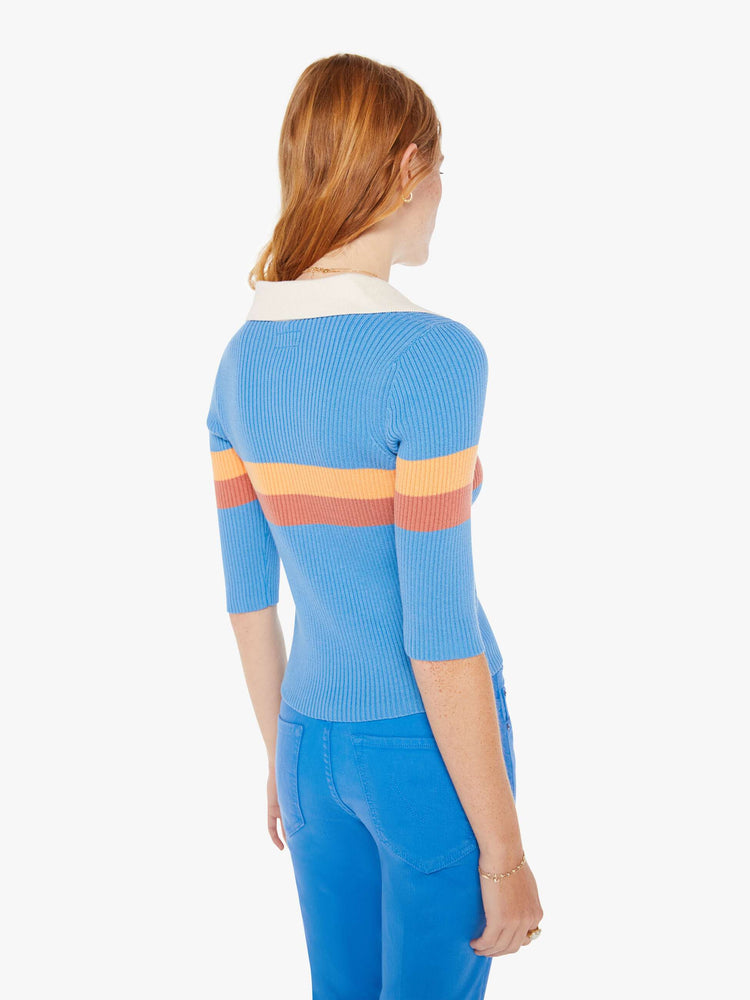 Back view of a woman blue with orange stripes collared blouse with a V-neck, elbow-length sleeves and a narrow fit.