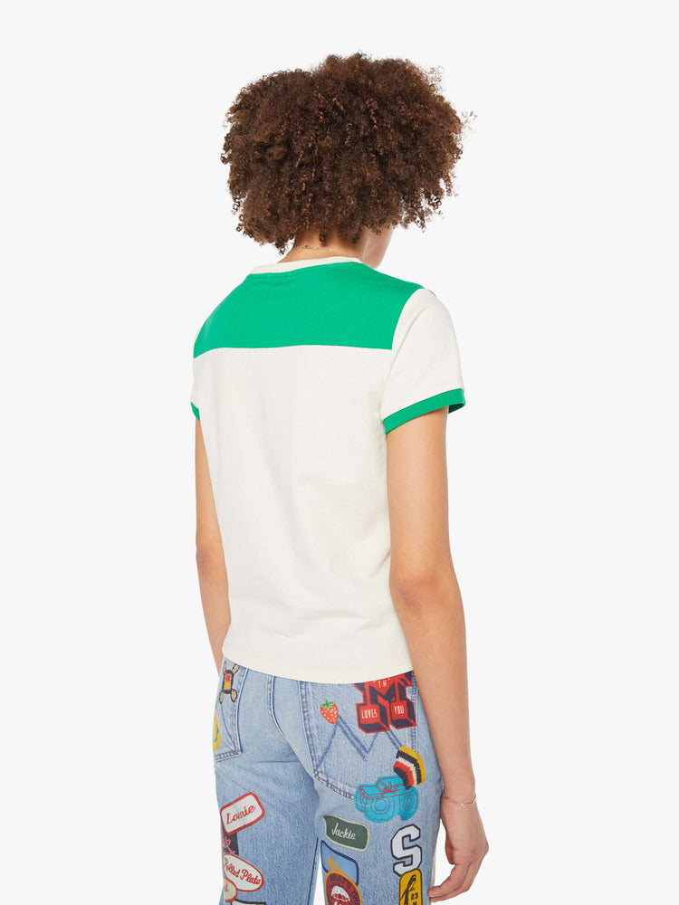 Back view of a woman in an off-white with green details tee and features a hand-drawn motorcycle graphic and MOTHER's name in pink fuzzy text on the chest.