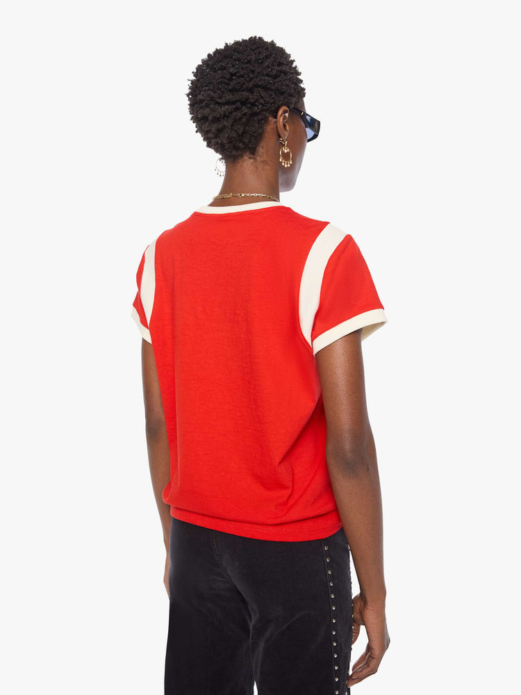 Back view of a woman in a red tee features a small cheetah graphic and MOTHER's name in blue across the front.