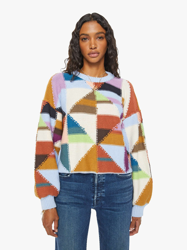 Front view of a womens multi color block sweater featuring a cropped body and billow sleeves.