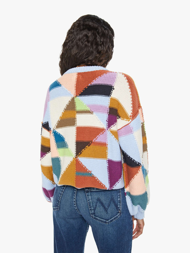 Back view of a womens multi color block sweater featuring a cropped body and billow sleeves.