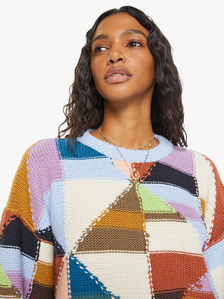 Front close up view of a womens multi color block sweater.
