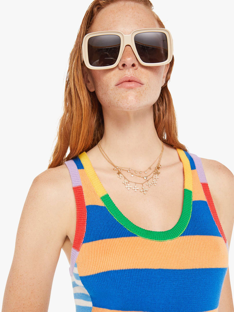 Front close up view of a woman wearing a colorful, multi pattern knit mini dress featuring a tank top.