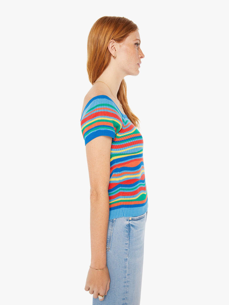 Side view of a woman rainbow of primary colors square neck, slightly off-the-shoulder short sleeves and a narrow fit.