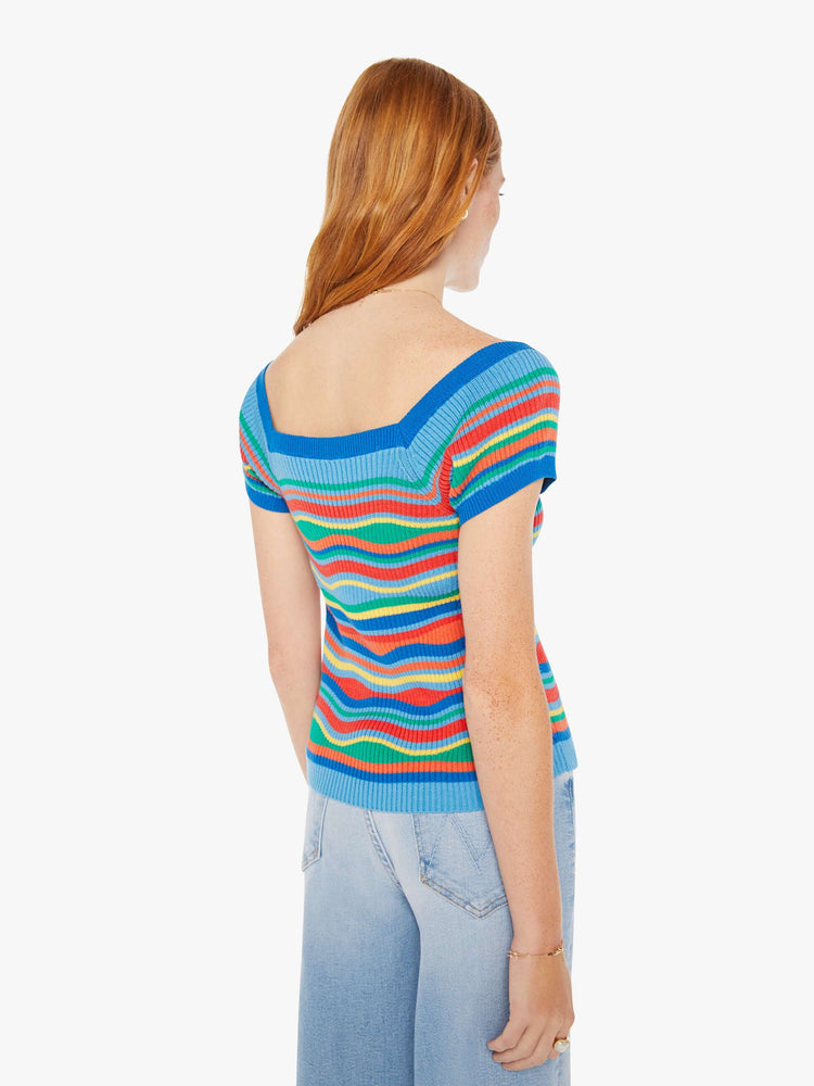 Back view of a woman rainbow of primary colors square neck, slightly off-the-shoulder short sleeves and a narrow fit.