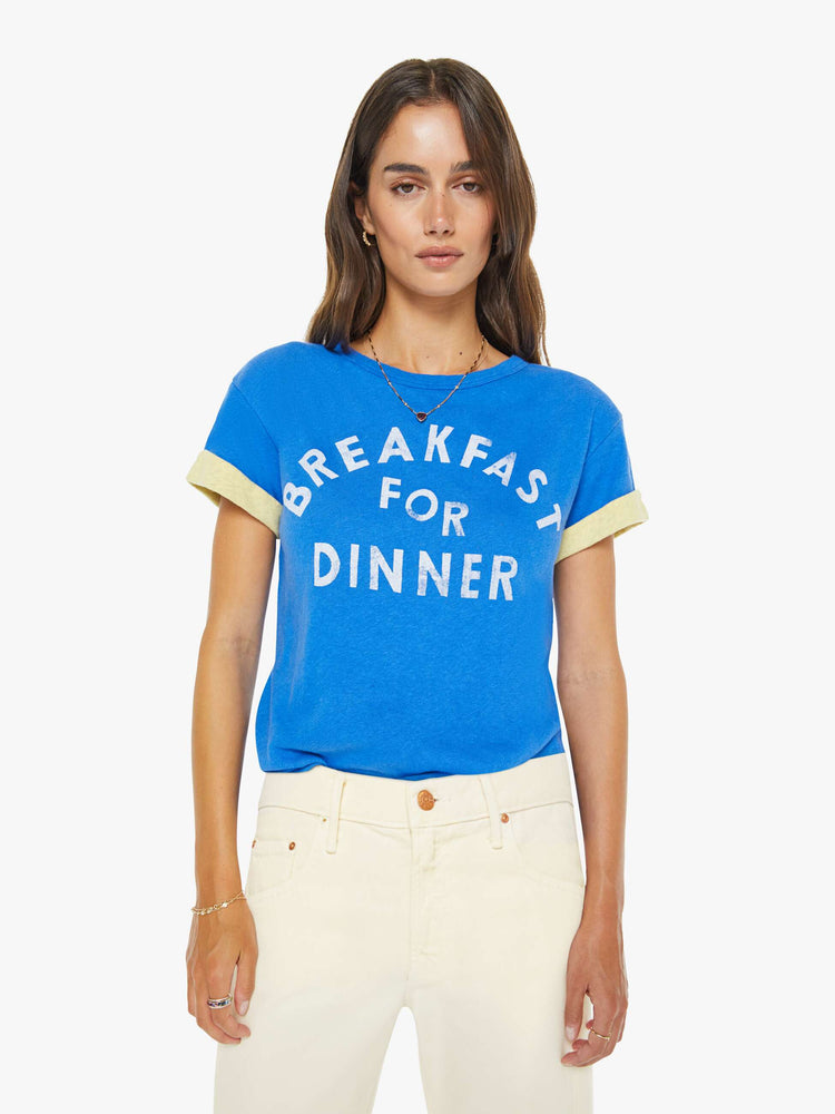 Front view of a womens blue tee in a cropped boxy fit featuring a white graphic and a yellow rolled cuff sleeve.