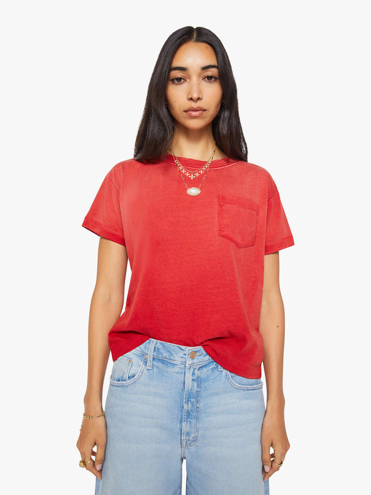 Front view of a woman in a red top with sun-fading across the chest and shoulders.