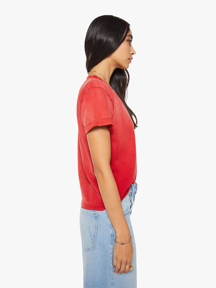 Side view of a woman in a red top with sun-fading across the chest and shoulders.