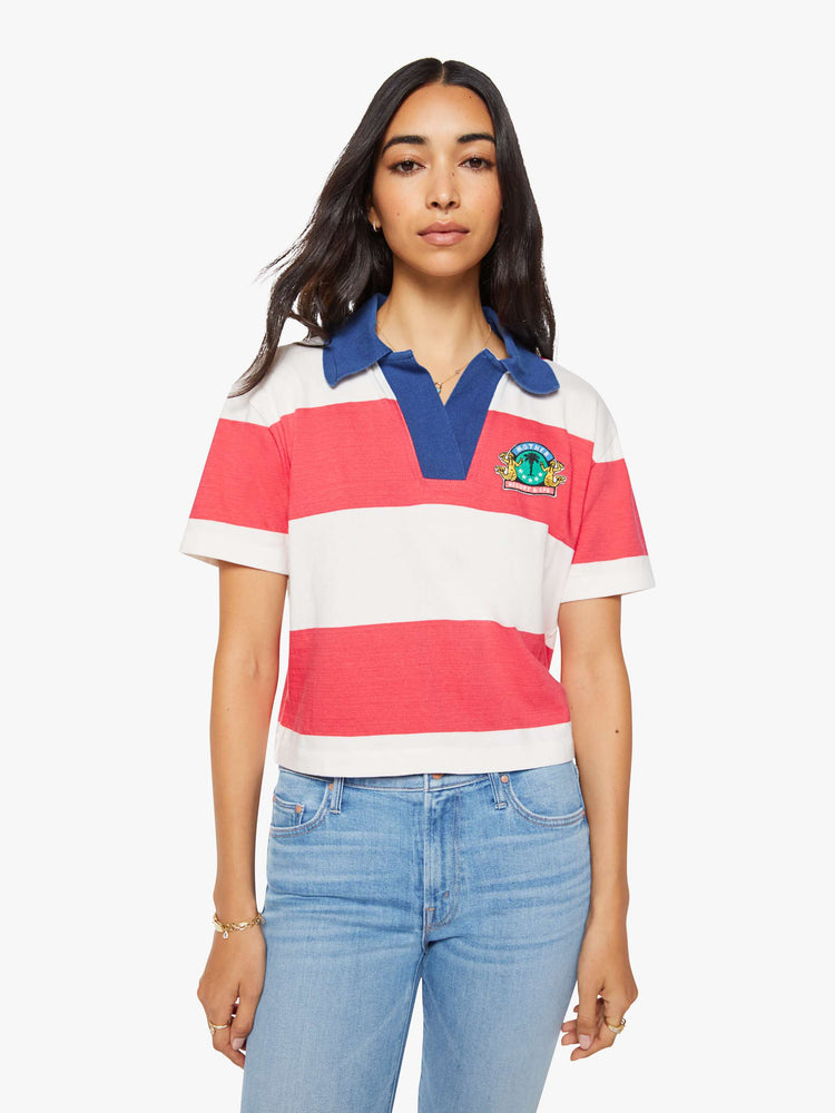 Front view of a woman in a collared top with short sleeves, a V-neck and a loose fit.