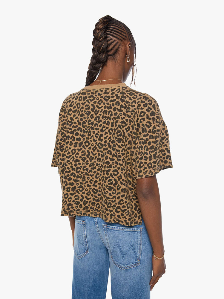 Back view of a woman in cheetah cropped crew neck tee with drop shoulders, short sleeves and a boxy fit.