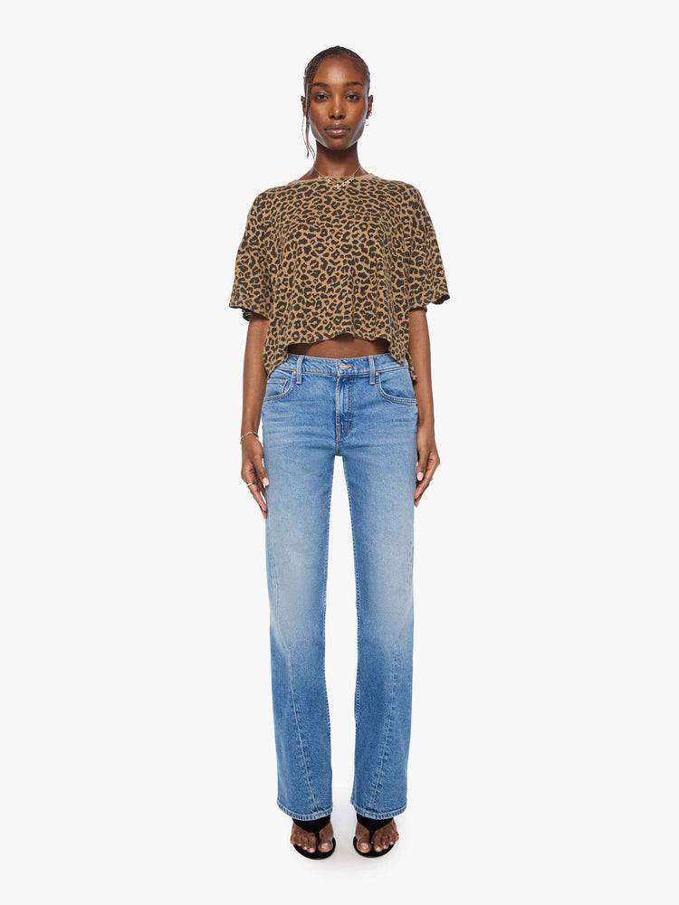 Full body view of a woman in cheetah cropped crew neck tee with drop shoulders, short sleeves and a boxy fit.
