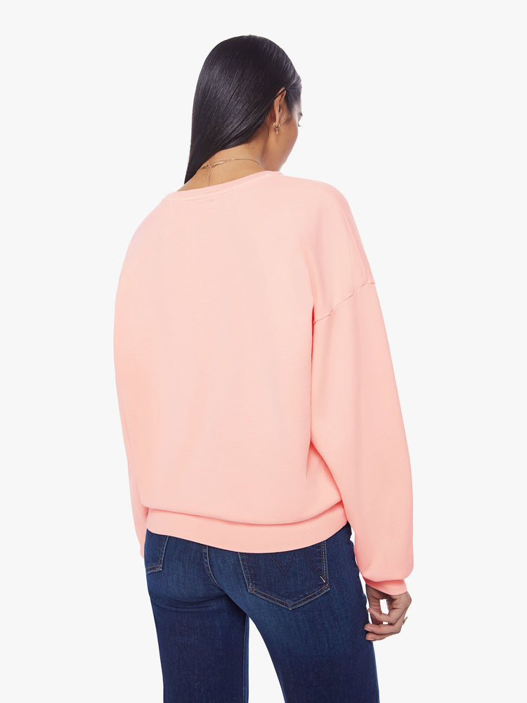 Back view of a woman light pink sweatshirt with dropped sleeves with a hand-drawn doodle of a barn in flames.