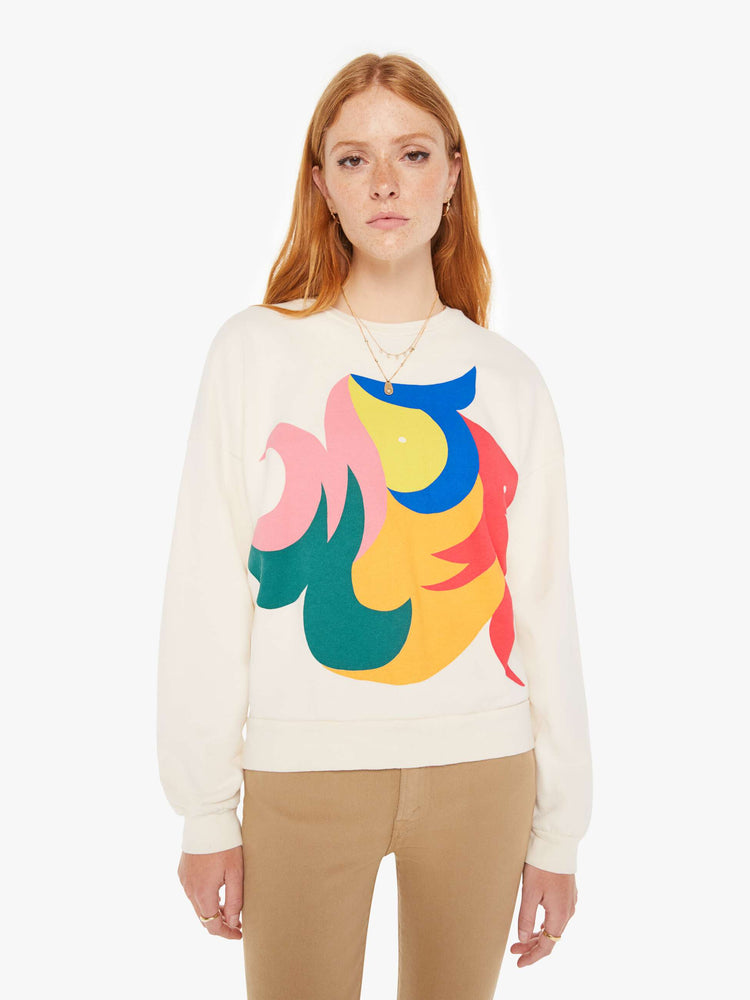 Front view of a womens ivory crew neck sweatshirt featuring a large colorful graphic.