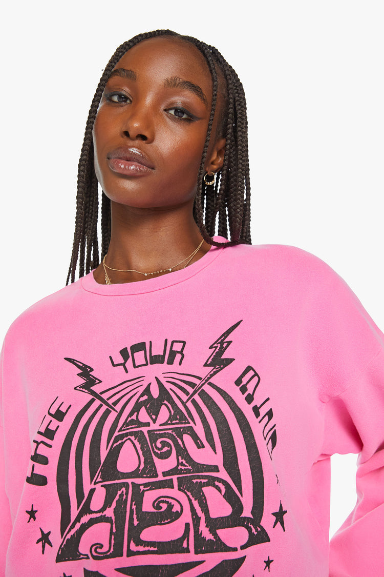 Close up view of a woman crewneck sweatshirt with dropped sleeves in hot pink with black graphic.