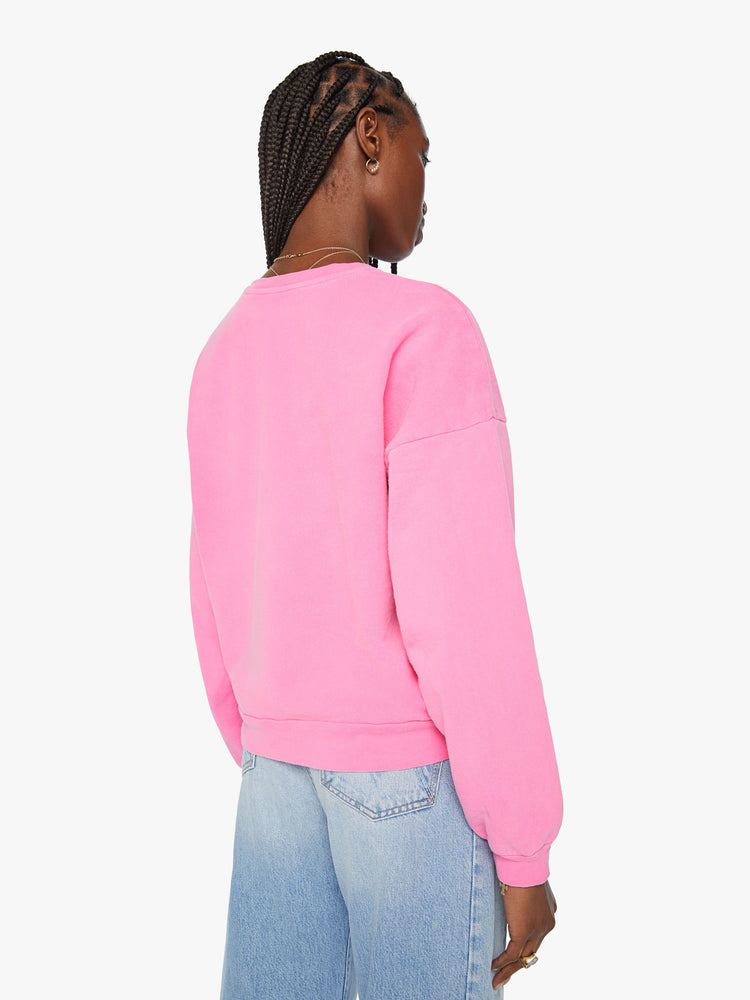 Back view of a woman crewneck sweatshirt with dropped sleeves in hot pink with black graphic.
