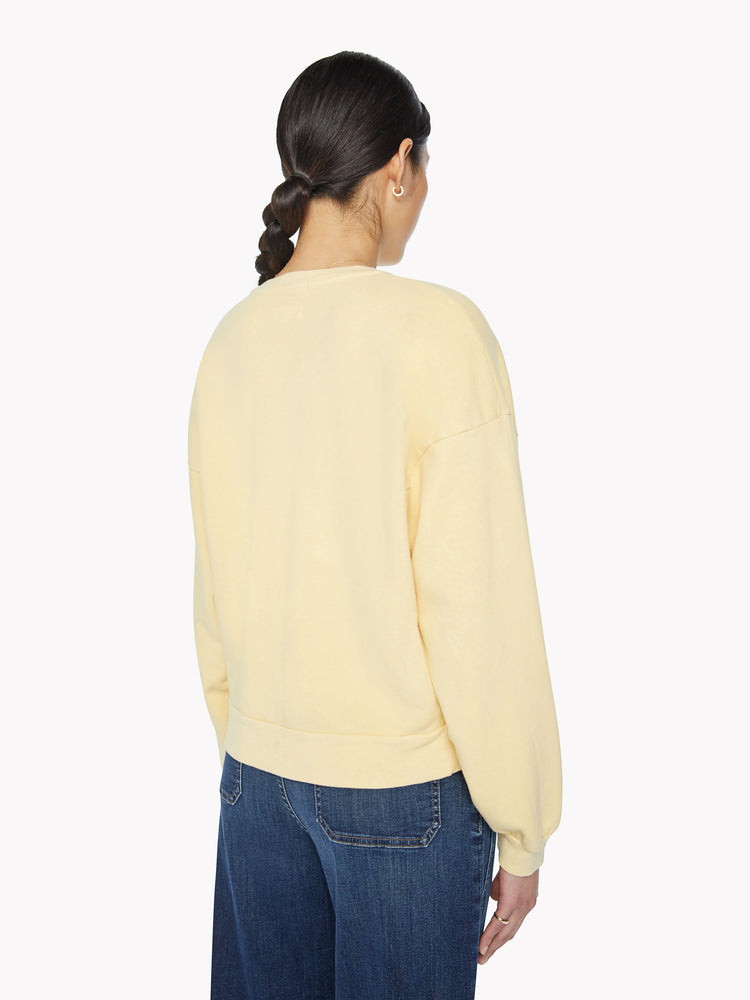 Back view of a woman crewneck sweatshirt with dropped sleeves and relaxed fit in a pastel yellow.