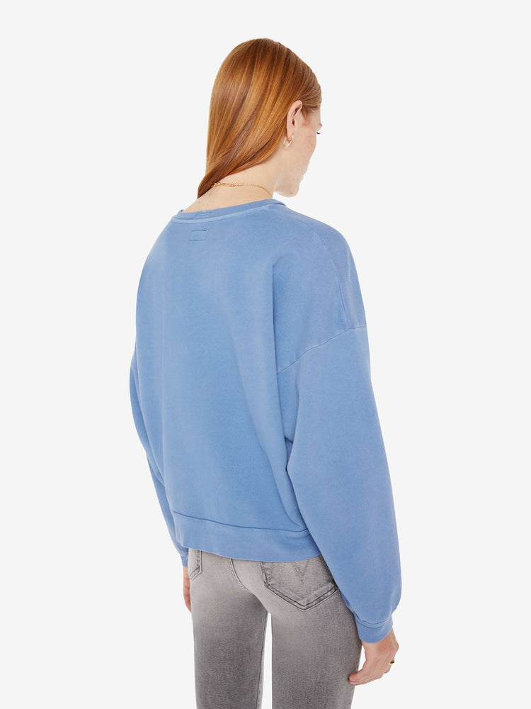 Back view of a womens faded blue sweatshirt.