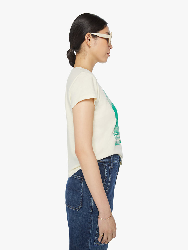 Side view of a woman off white with faded green graphic horses crewneck slit fit tee.