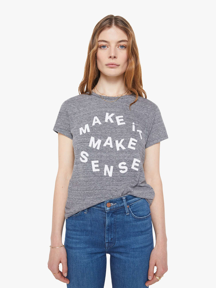 Front view of a woman in  heathered grey tee features white block text on the front.